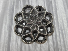 Load image into Gallery viewer, Silver Cut out sand cast, pendant displayed on top of a shiny silver cloth 

