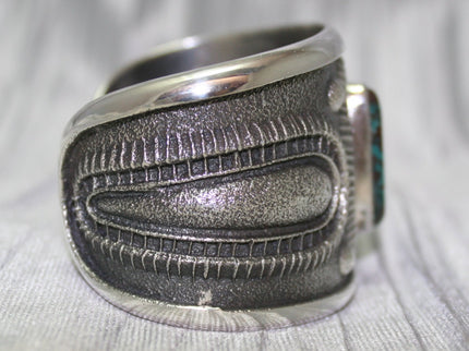 A bold sand-cast cuff featuring intricate textures and patterns, Side Profile. The design reflects a balance of rugged craftsmanship and refined artistry.