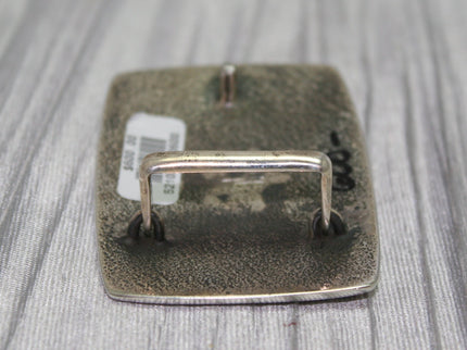 Flat back view of buckle with loop standing up
