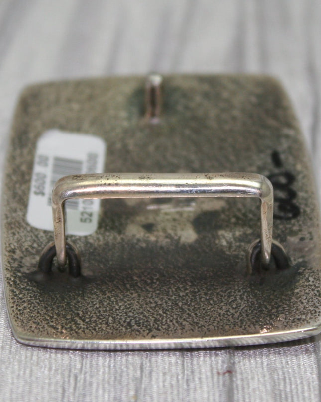 Flat back view of buckle with loop standing up