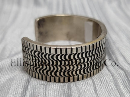heavy silver, Bracelet features intricate stamped detailing for a unique and stylish look. Displayed on a soft silver cloth, Side