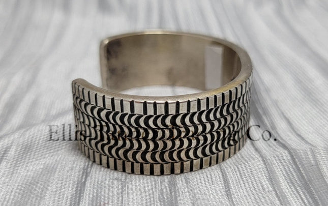 heavy silver, Bracelet features intricate stamped detailing for a unique and stylish look. Displayed on a soft silver cloth, Side