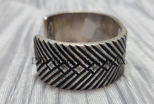 Load image into Gallery viewer, heavy, etched diamond designs front view of bracelet, displayed on top of a silver shiny cloth, side 

