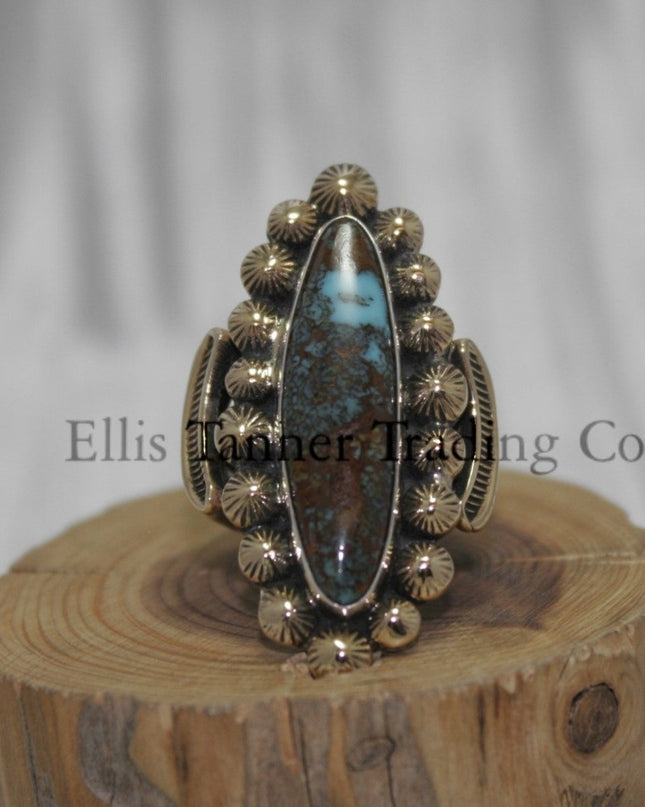 Tommy Jackson 14k overlay with Bisbee turquoise on wooden display 