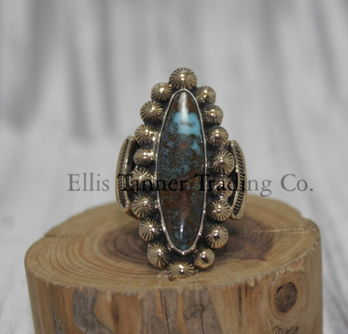 Tommy Jackson 14k overlay with Bisbee turquoise on wooden display 