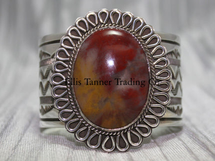 Large silver stamped cuff, with a center Agate stone surrounded with a rope and half round small cut out petals,