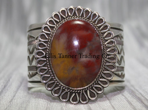 Large silver stamped cuff, with a center Agate stone surrounded with a rope and half round small cut out petals,