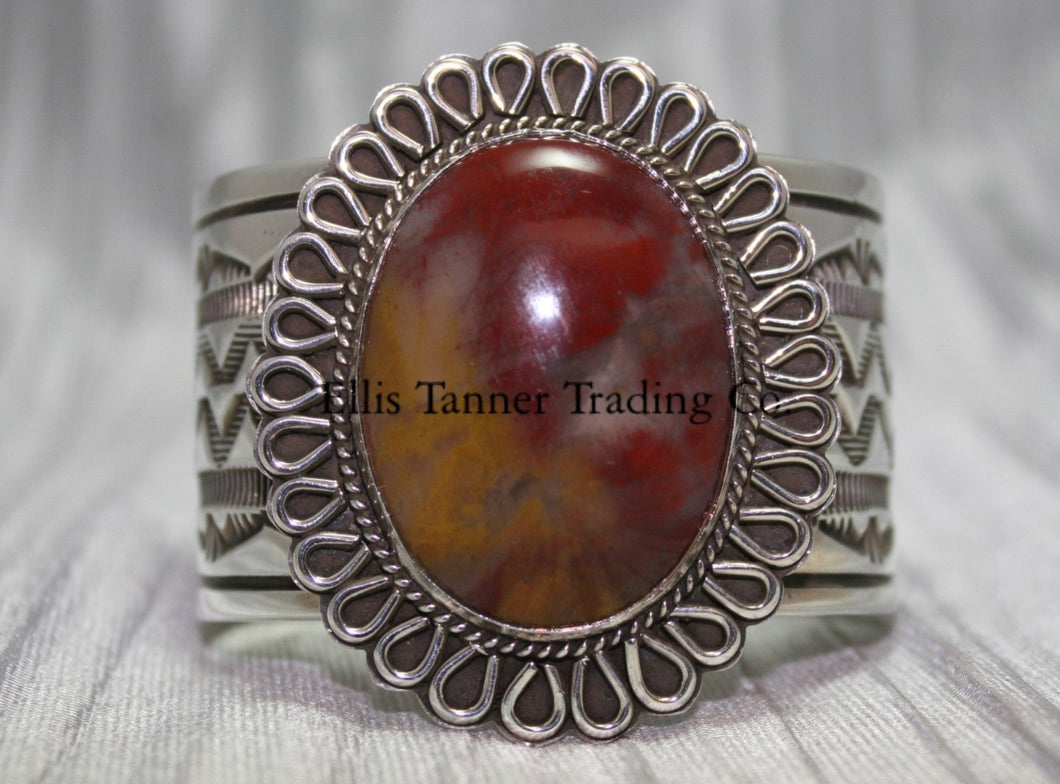 Large silver stamped cuff, with a center Agate stone surrounded with a rope and half round small cut out petals,