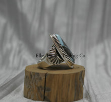 Load image into Gallery viewer, Tommy Jackson Black Diamond Turquoise side view, stamped overlay on top of band, On top of wooden display 
