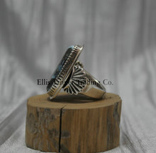 Load image into Gallery viewer, Tommy Jackson Black Diamond Turquoise side view, stamped overlay on top of band, On top of wooden display 
