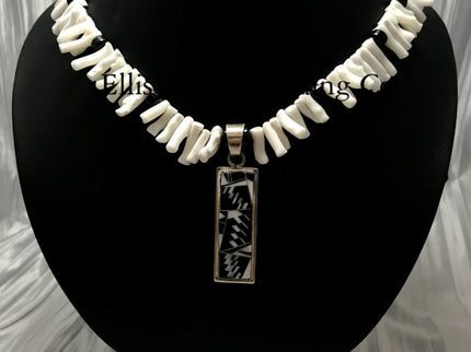 White coral choker with black onyx beads, in the center is a rectangular silver inlayed onyx and white coral pendant. 