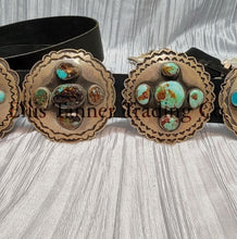 Load image into Gallery viewer, A handcrafted Navajo concho belt with detailed sterling silver conchos, each embedded with mixed turquoise stones of varying shades and natural patterns, attached to a black leather strap.
