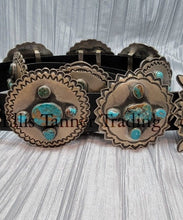 Load image into Gallery viewer, A handcrafted Navajo concho belt with detailed sterling silver conchos, each embedded with mixed turquoise stones of varying shades and natural patterns, attached to a black leather strap.
