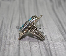 Load image into Gallery viewer, Side profile of a Bisbee Turquoise ring showcasing the raised oval turquoise stone with brown veining, set in a detailed silver bezel. the band’s craftsmanship is visible, emphasizing the ring&#39;s dimensional design.
