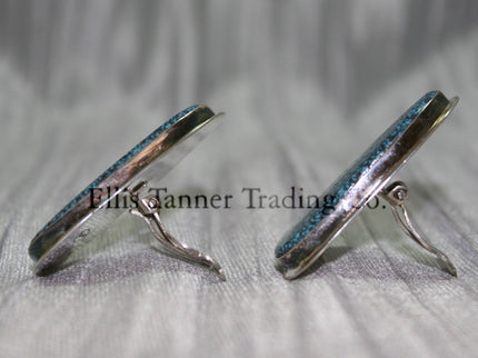 Silver slab-style clip-on earrings Side View set in sterling silver bezels, displayed against a textured silver background.