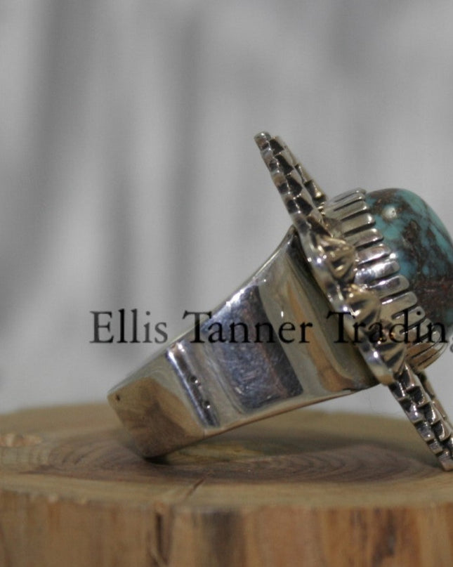 Silver Ring ,zigzag 14k overlay with round Bisbee turquoise in center, on a wooden display side 
